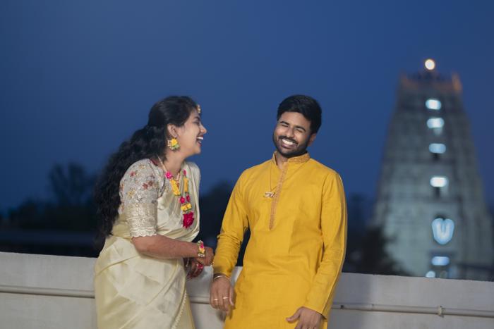couple at blue hour with lit tower