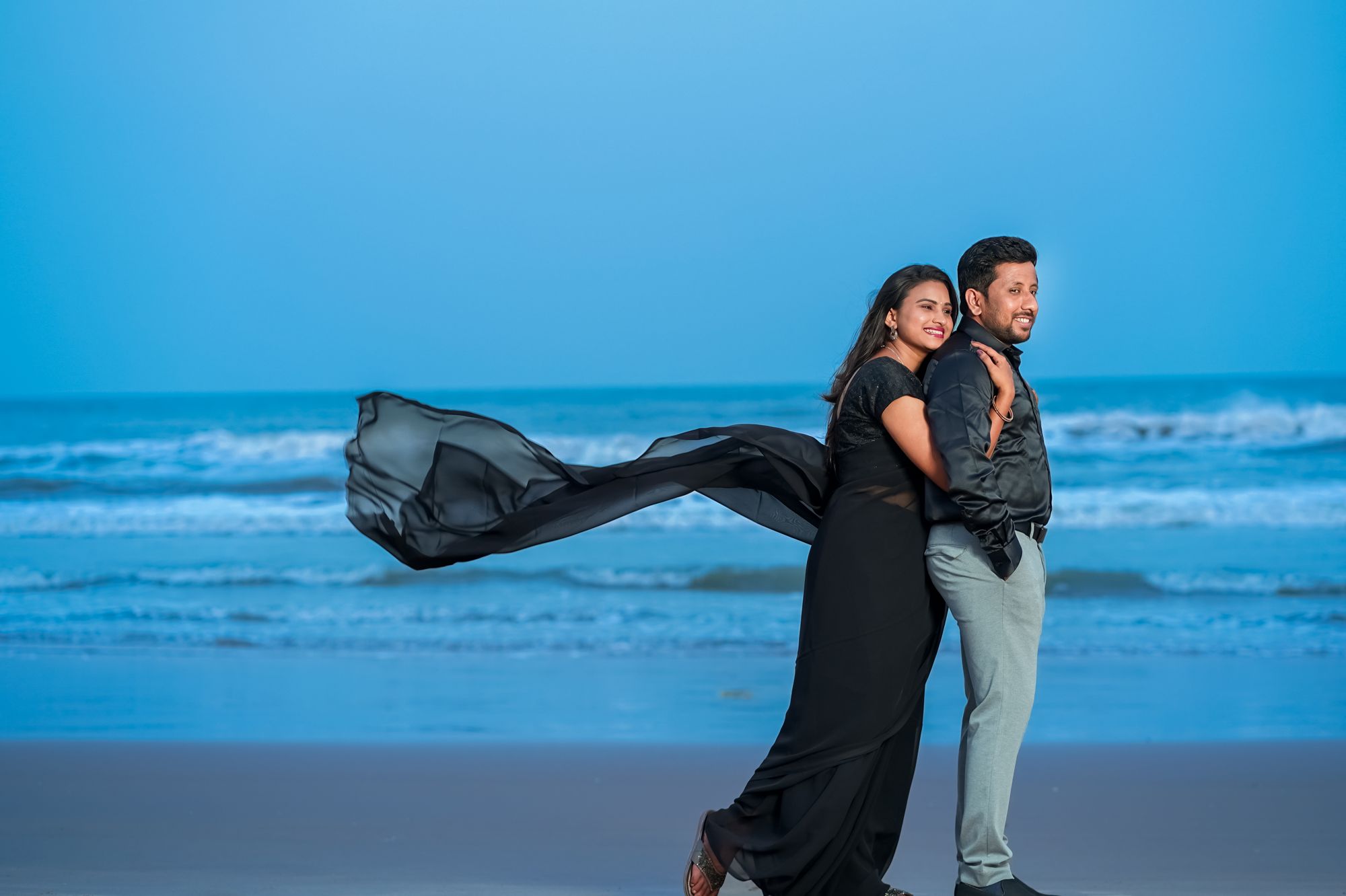 couple blue sea flowing dress