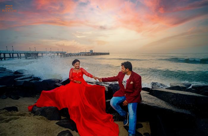 red saree sunset sea rocks